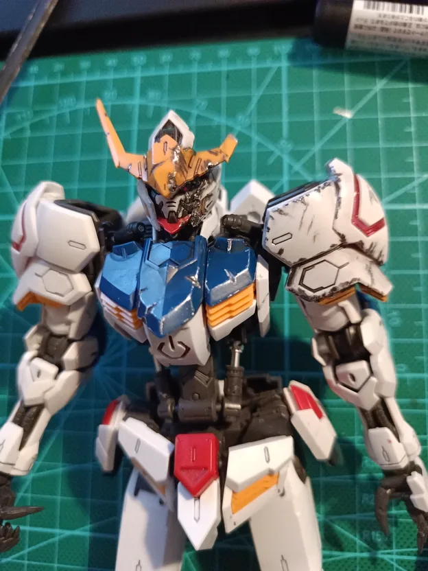 Gundam Barbatos model kit, painted and weathered, standing on a cutting mat